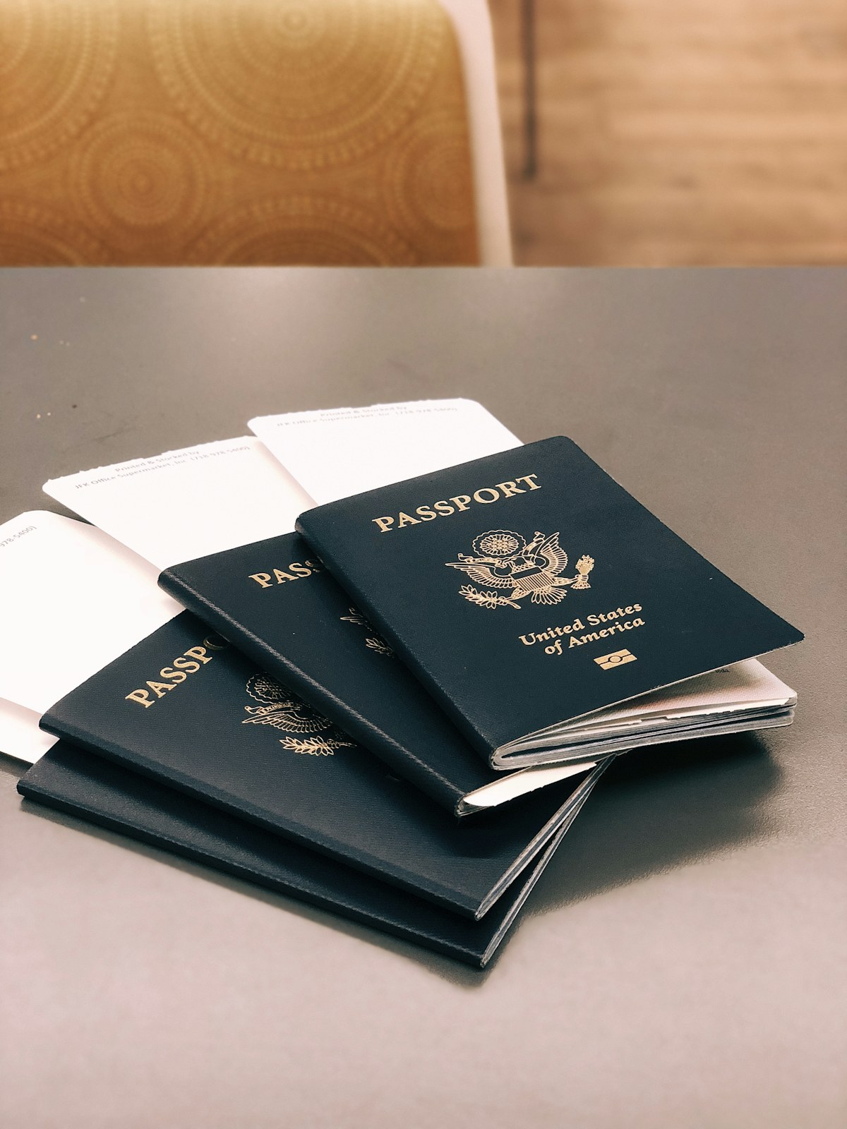 Four international passports on a desk — Cosmos Immigration document review for UAE residents pursuing Canada, Australia, UK and other PR pathways